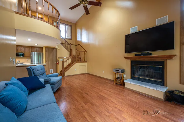 a view of staircase with wooden floor and windows