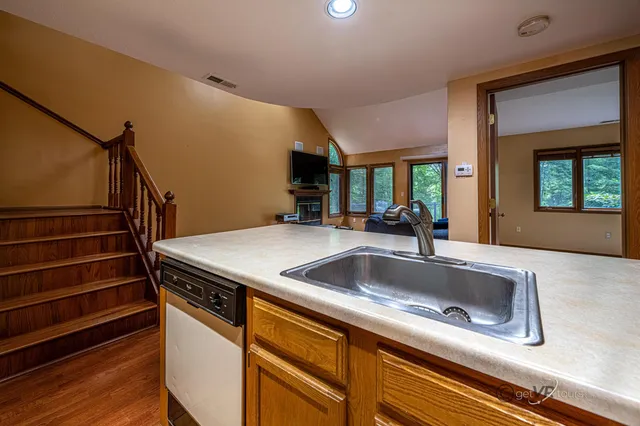a kitchen with sink and mirror