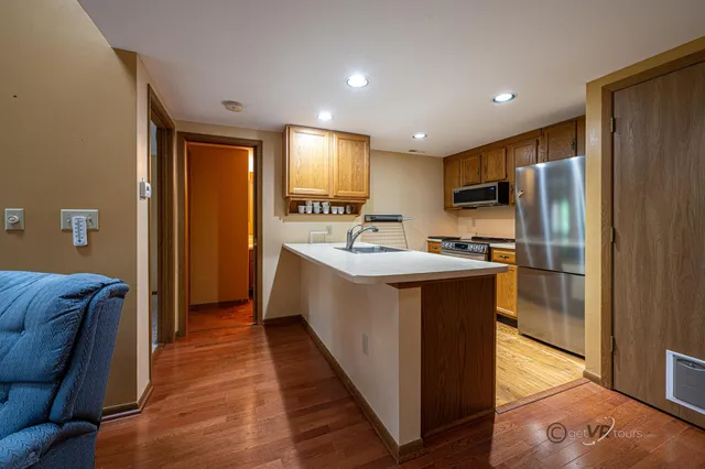 a kitchen with stainless steel appliances a sink stove and refrigerator