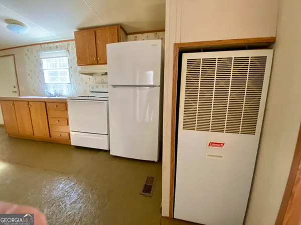 a white refrigerator freezer sitting in a kitchen
