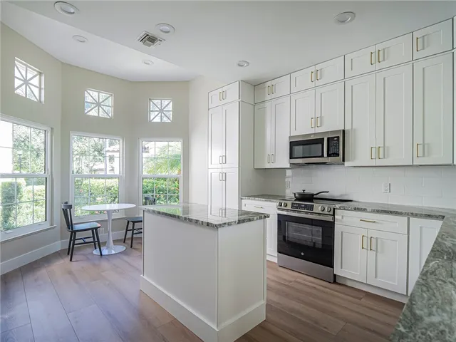 a kitchen with a stove a sink and a microwave