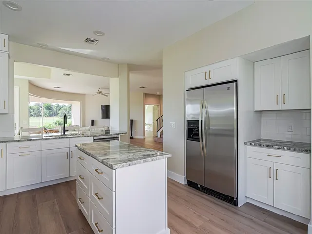 a kitchen with white cabinets stainless steel appliances and sink
