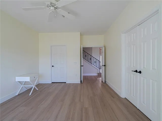a view of a room with wooden floor and white walls