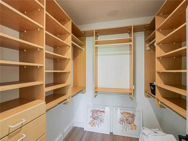 a view of walk in closet with empty racks