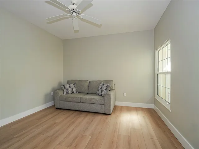 a living room with furniture and a hard wood floor