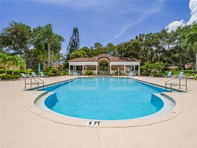 a view of a swimming pool with an outdoor seating