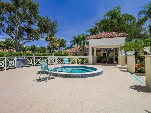 a view of a swimming pool with a patio and a yard