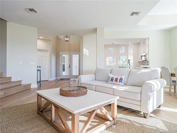 a living room with furniture a sink and a mirror