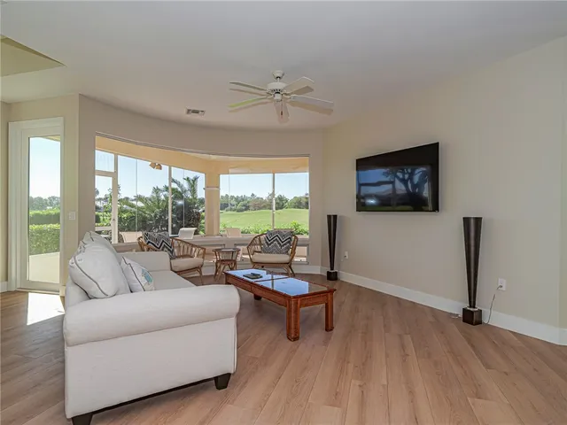 a living room with furniture and a floor to ceiling window