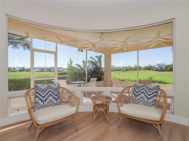 a living room with furniture and a floor to ceiling window