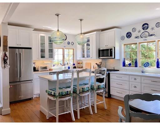 12 Long Beach Road Gloucester, MA 01930 - Photo 4 of 30 a kitchen with white cabinets and stainless steel appliances