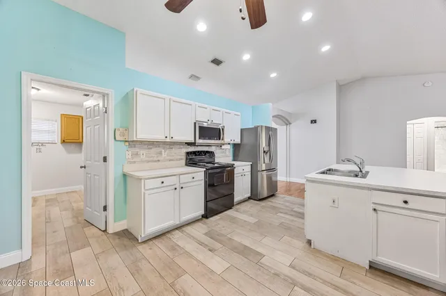 a view of a livingroom with a hardwood floor and a ceiling fan