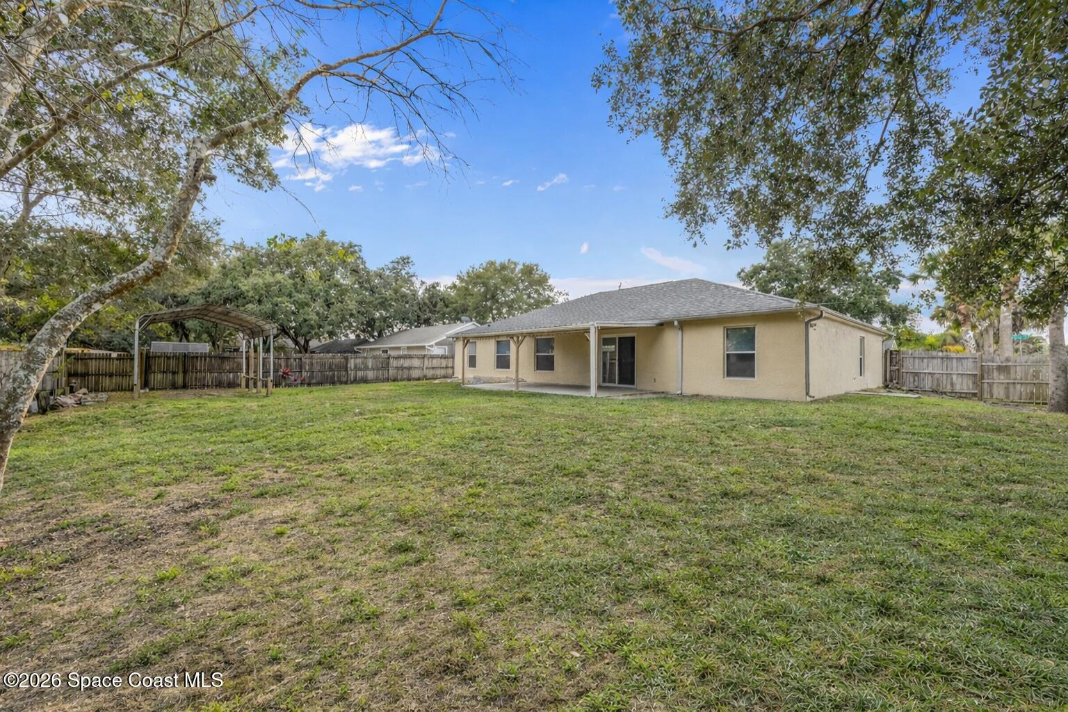 6185 Degan Road Cocoa, FL 32927 - Photo 28 of 30 a front view of a house with a yard