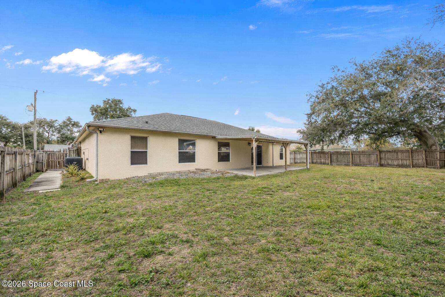 6185 Degan Road Cocoa, FL 32927 - Photo 29 of 30 a view of a yard in front of a house with a large tree