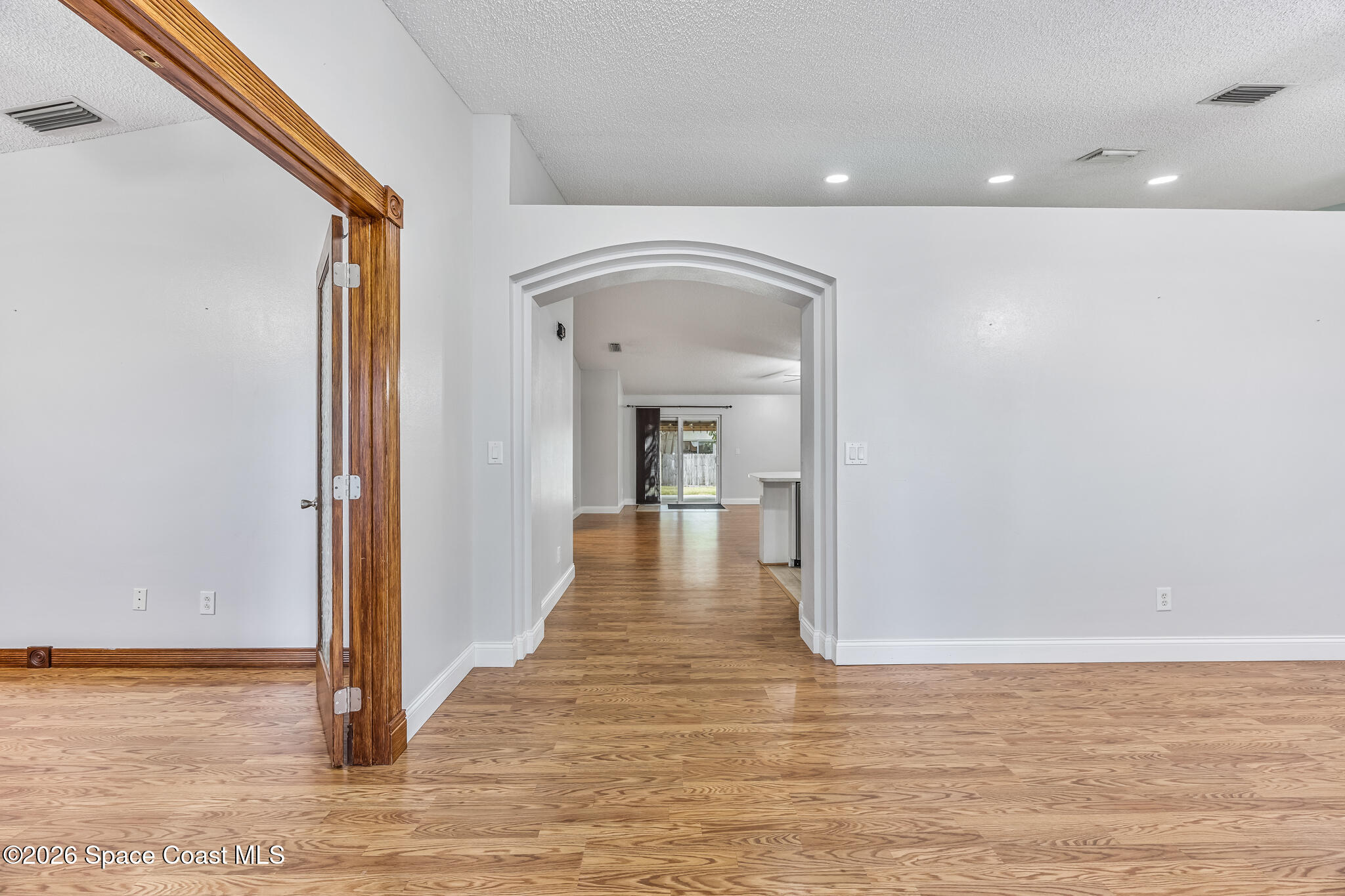 6185 Degan Road Cocoa, FL 32927 - Photo 6 of 30 a view of a hallway view with wooden floor and staircase