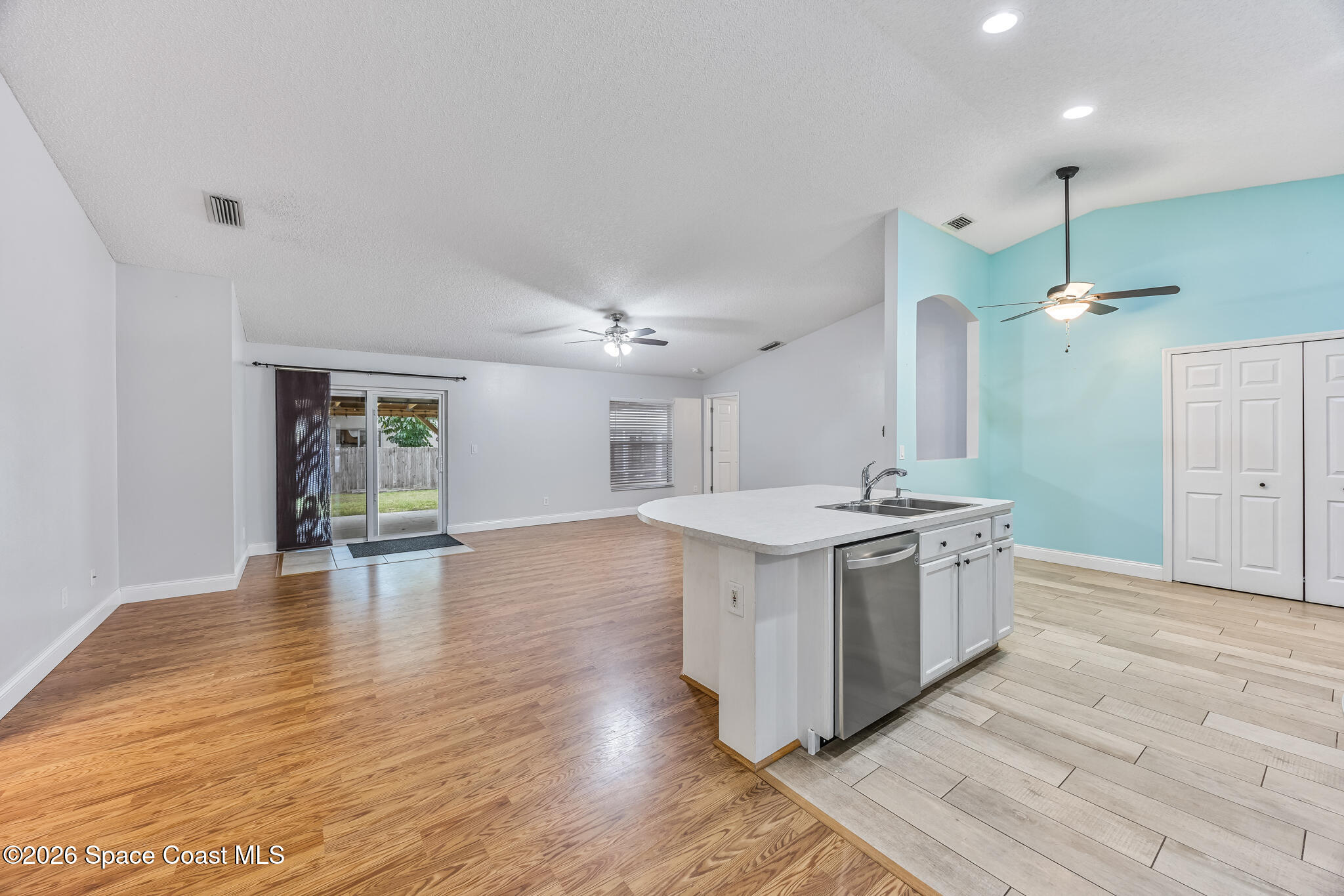 6185 Degan Road Cocoa, FL 32927 - Photo 10 of 30 a kitchen with a stove and a wooden floors