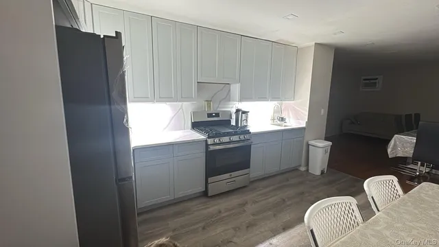 a kitchen with a refrigerator stove and white cabinets