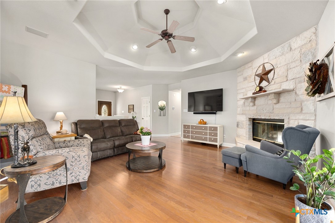 106 Starlight Trail Georgetown, TX 78633 - Photo 13 of 47 Living Room with Stone Fireplace, High Ceiling, Wood flooring.