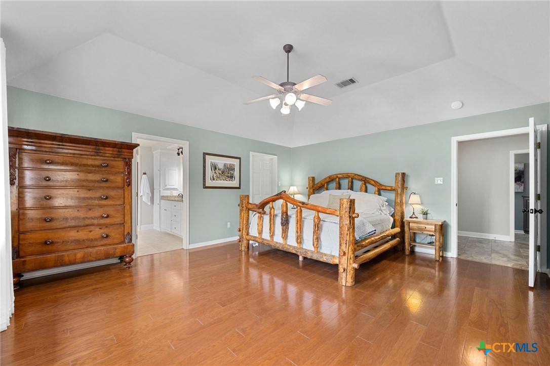 106 Starlight Trail Georgetown, TX 78633 - Photo 22 of 47 Primary Bedroom - Coffered Ceiling, Wood flooring,