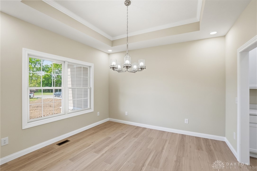 4600 Beal Road Franklin, OH 45005 - Photo 14 of 42 This bright space features a striking chandelier and hardwood floors, creating an inviting atmosphere.