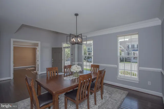a view of a house with a small yard and floor to ceiling window