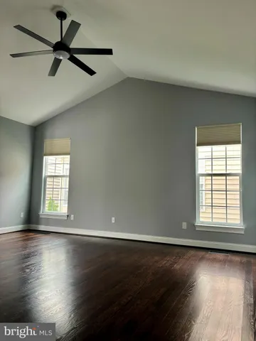 a view of a livingroom with wooden floor and a flat screen tv