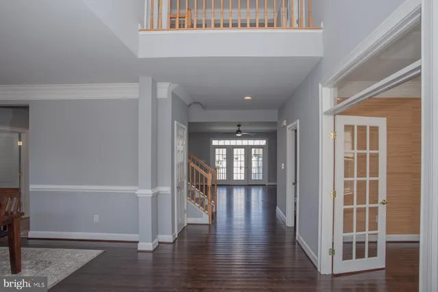 a view of empty room with wooden floor and windows