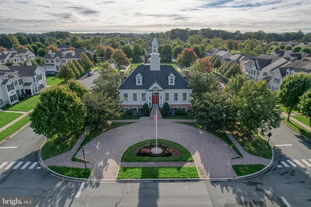 a front view of a house with a yard and plants
