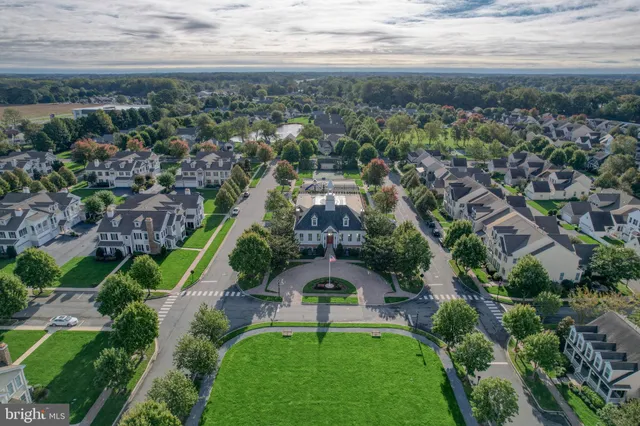 an aerial view of multiple houses with a yard