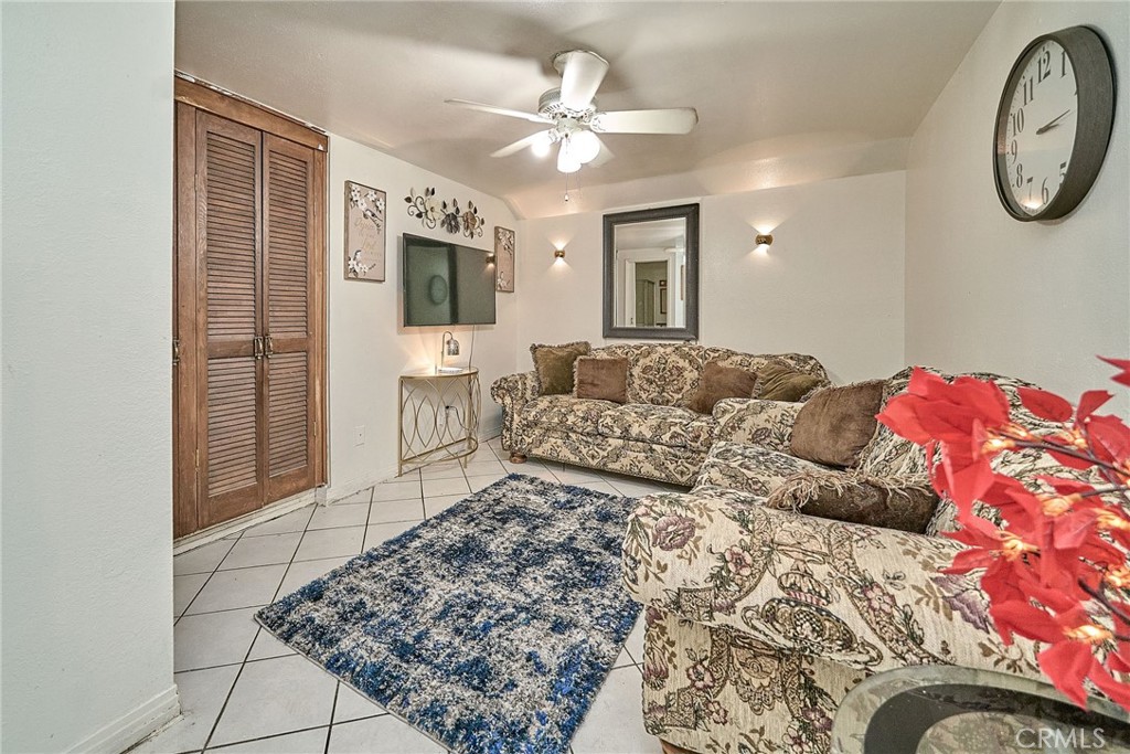 4801 Jackson Street, Unit C Riverside, CA 92503 - Photo 16 of 56 a living room with a bed furniture and a flat tv screen
