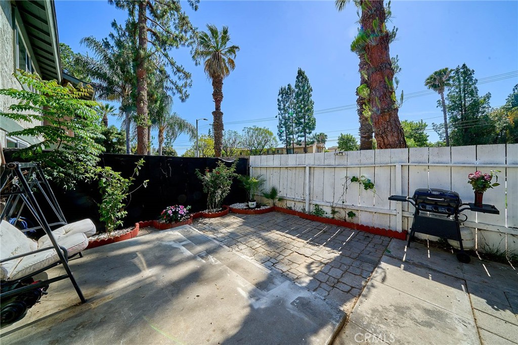 4801 Jackson Street, Unit C Riverside, CA 92503 - Photo 33 of 56 a view of backyard with a table and chairs couches under an umbrella