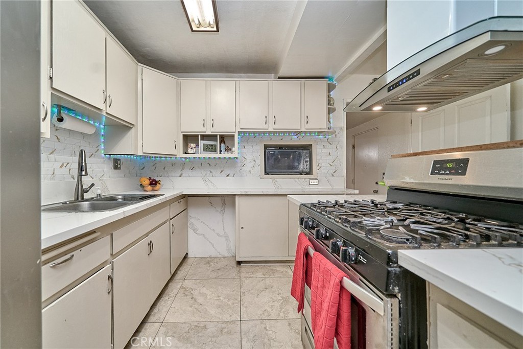 4801 Jackson Street, Unit C Riverside, CA 92503 - Photo 4 of 56 a kitchen with stainless steel appliances granite countertop a stove sink and cabinets