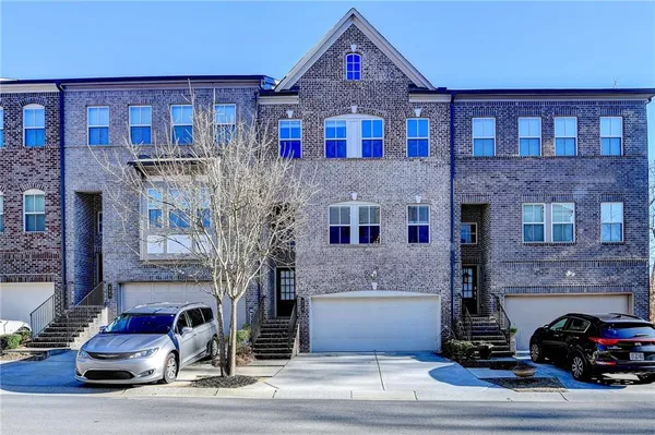 a front view of a house with parking space