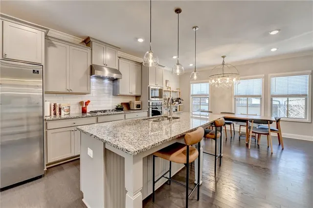 a kitchen with center island table and chairs