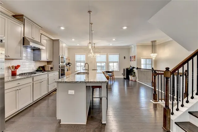 a kitchen with stainless steel appliances granite countertop lots of counter top space