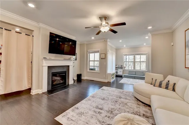 a living room with furniture a fireplace and a flat screen tv