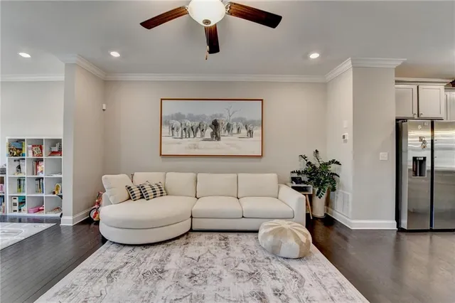 a living room with furniture potted plant and a couch