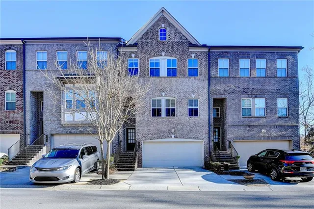 a front view of a house with parking space
