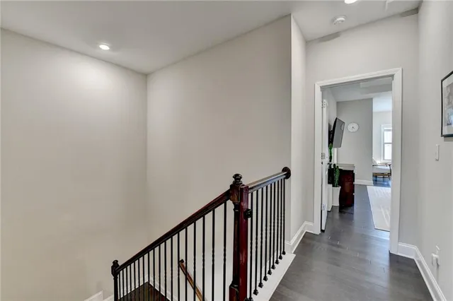 a view of a hallway with wooden floor and entryway