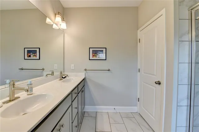 a bathroom with a sink double vanity and a mirror