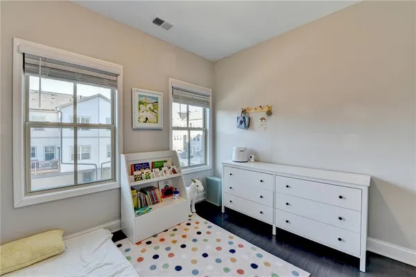 an empty room with white walls and stairs