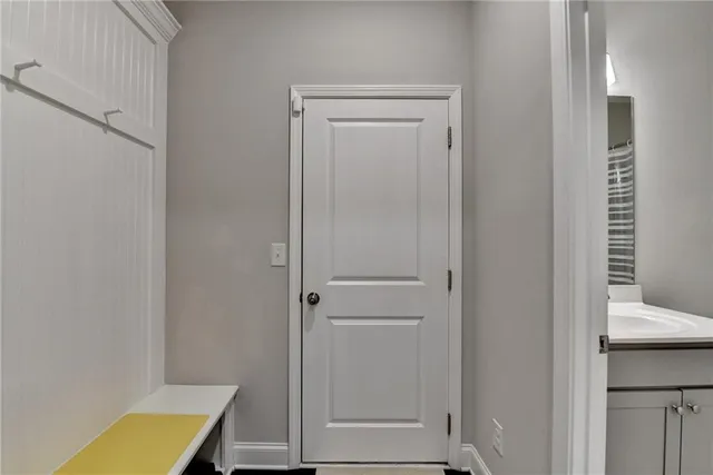 a bathroom with a sink a toilet and shower curtain