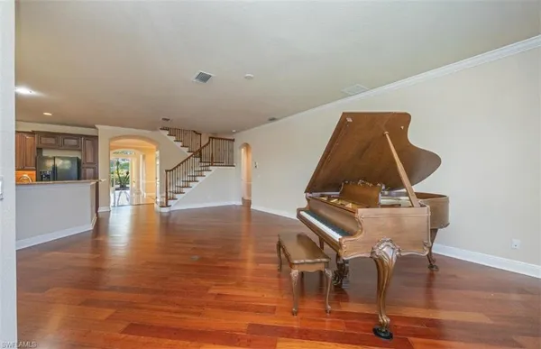 a view of a room with wooden floor and staircase