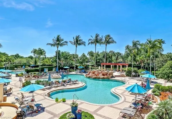 a view of a swimming pool with lounge chairs