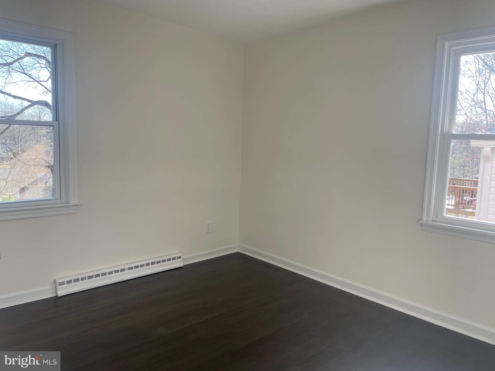 6107 Buckler Road Clinton, MD 20735 - Photo 17 of 45 an empty room with wooden floor and windows