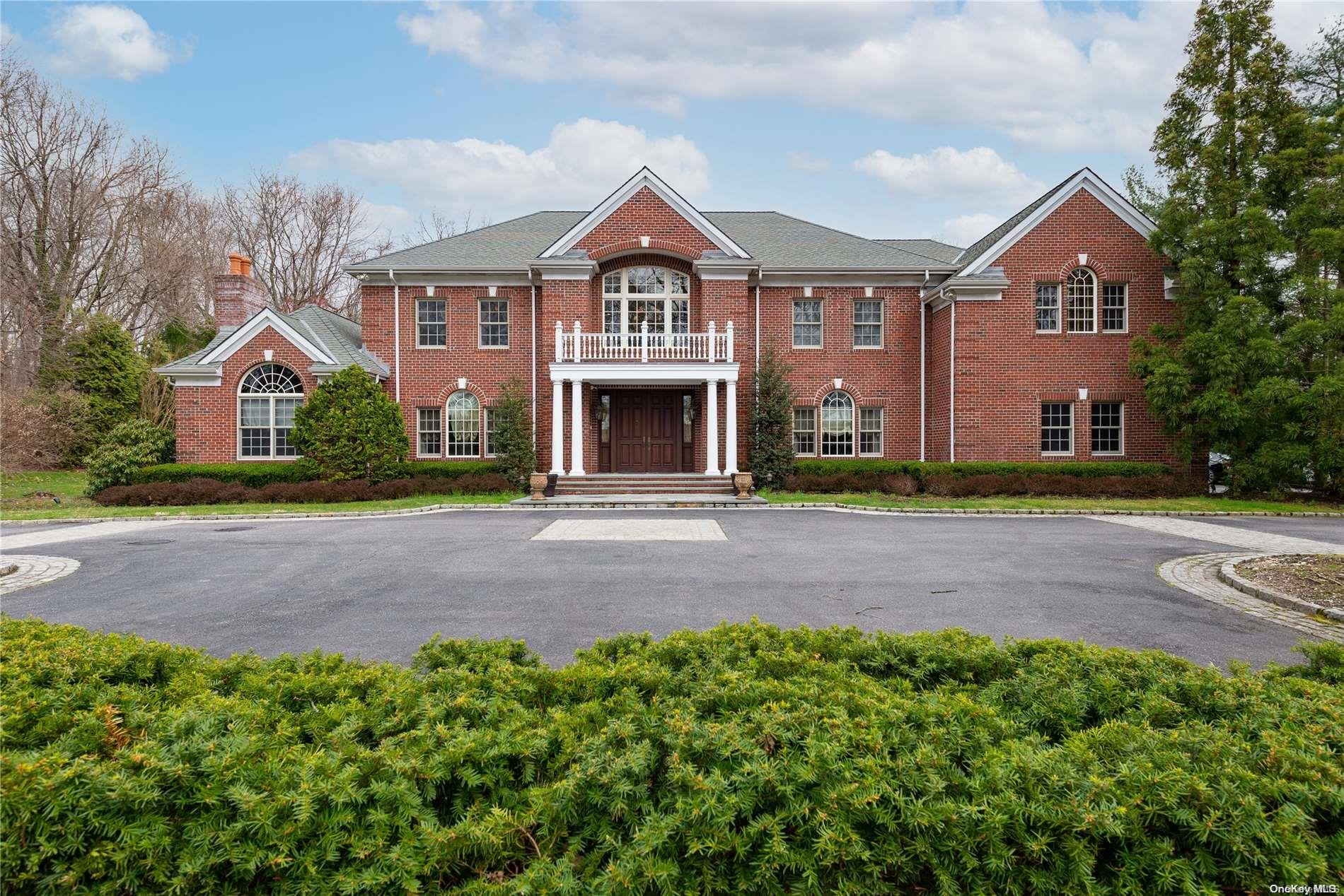 2042 Ridge Road Muttontown, NY 11791 - Photo 1 of 1 a front view of a house with a garden