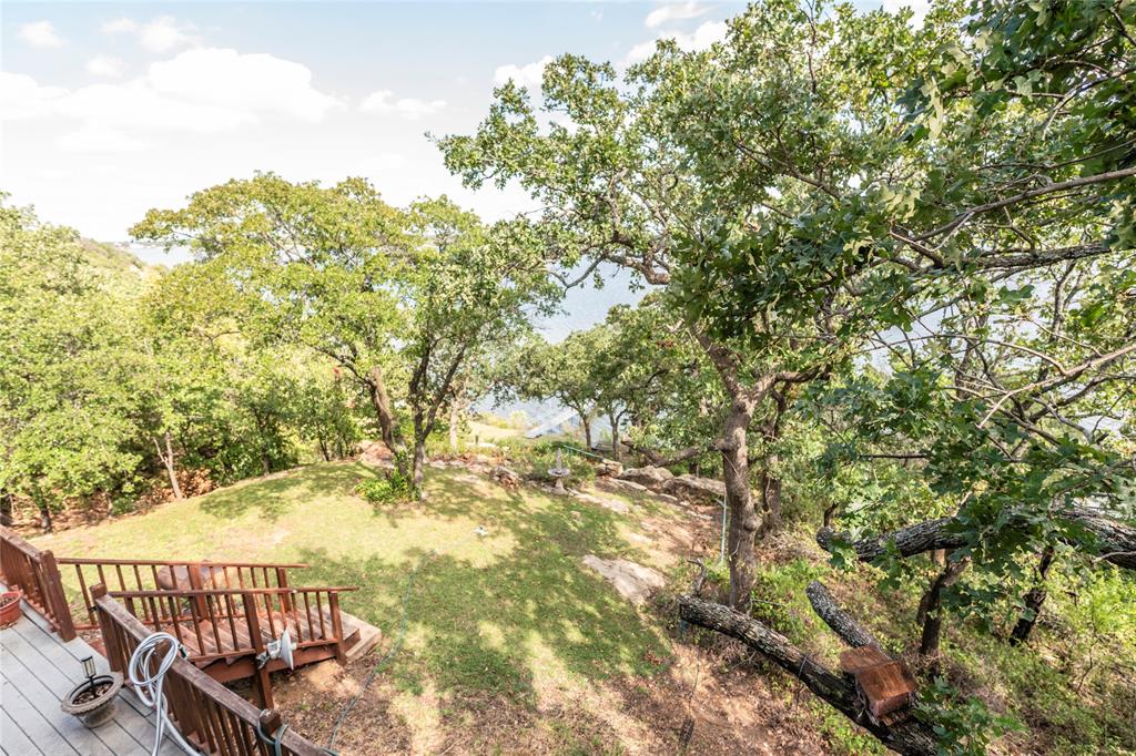 698 Storey Road Nocona, TX 76255 - Photo 13 of 34 View of grassy yard with a wooden deck