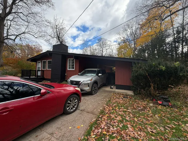 a view of a car parked front of a house