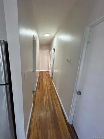 a view of hallway with wooden floor