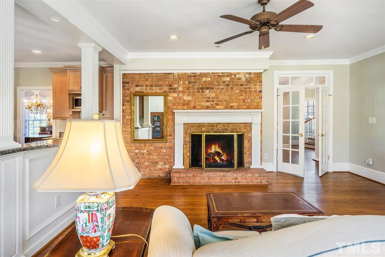 3201 Landor Road Raleigh, NC 27609 - Photo 11 of 25 a living room with a fireplace furniture and a large window